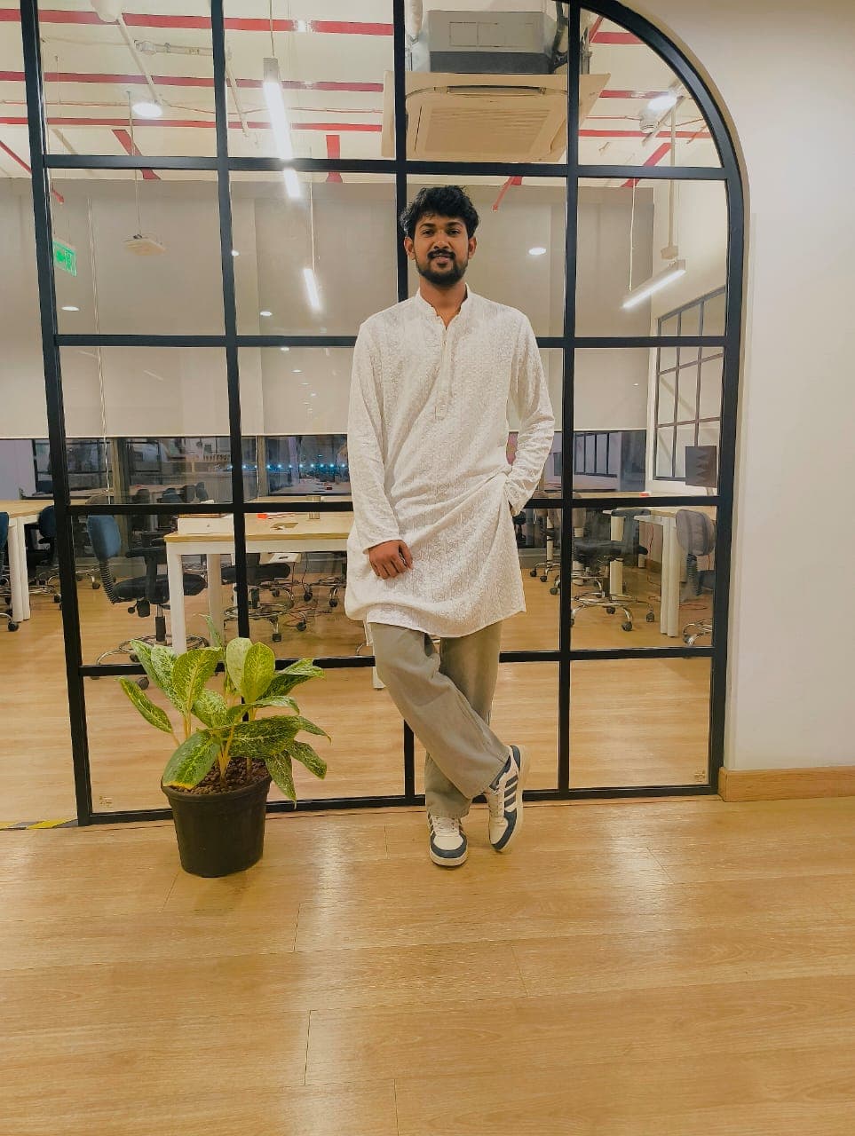 Office environment standing near glass partition